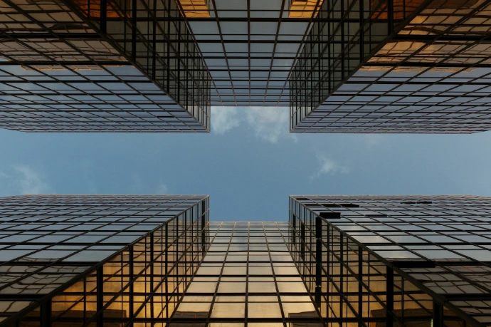 worm view photo of buildings under cloudy sky
